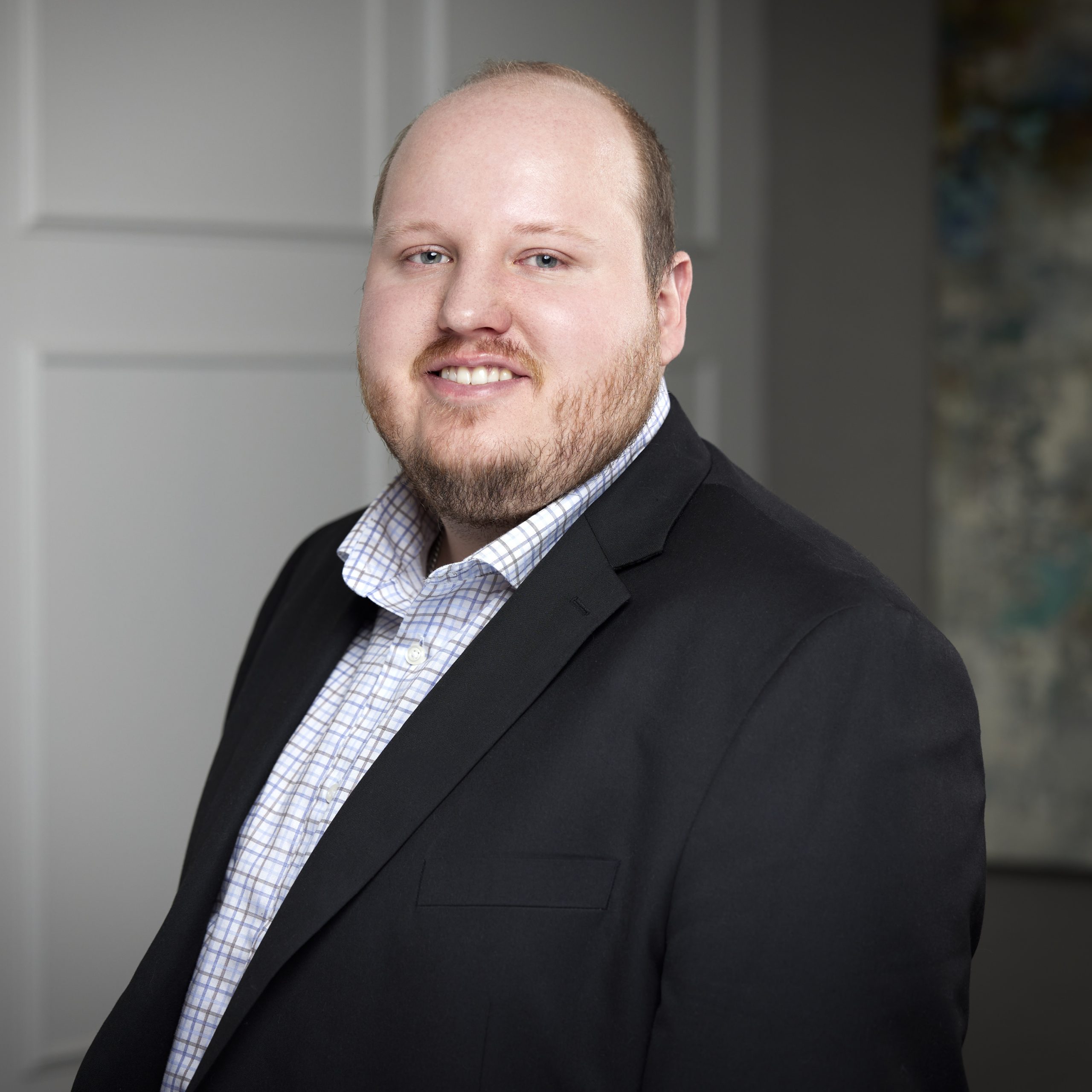 An image of Blake Devine in the Niagara Region office of DDL & Co.